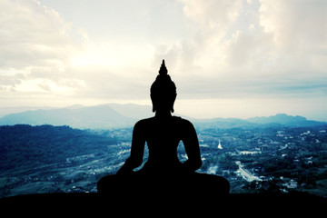 silhouette of buddha at sunset	