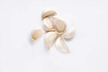 garlic cloves isolated on white. garlic is low in calories and rich in vitamin C, vitamin B6 and manganese, so it is in many dishes. It also contains trace amounts of various other nutrients