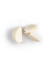 Fototapeta na wymiar three small peeled garlic cloves isolated on white. garlic is used as effective remedy or for health prophylaxis