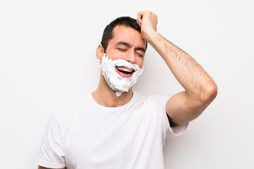 Man shaving his beard over isolated white background has realized something and intending the solution