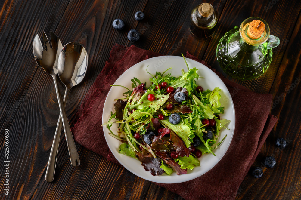 Wall mural bowl of fresh lettuce with berries