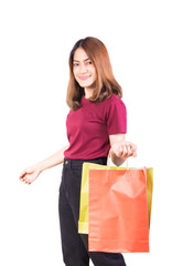 young woman pretty smiling holding paper bags green and orange shopping. on white background and looking at camera