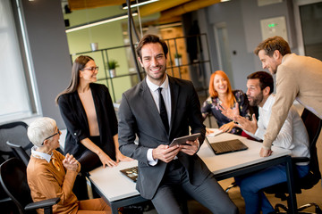 Young businessman using digital tablet in office