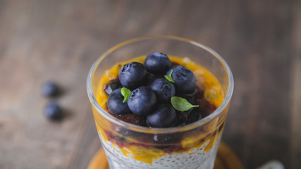 Fototapeta na wymiar Healthy dessert. Chia Pudding with Fresh Papaya Pulp and Blueberries