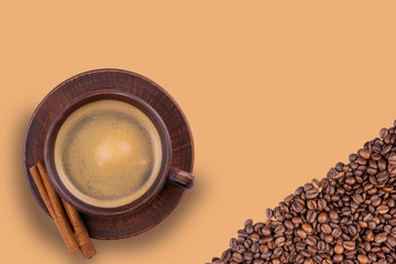 a Cup of coffee and coffee beans on an isolated background close up view from the top