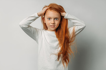 Naklejka premium attractive caucasian girl with long red hair isolated over white background. adorable, sweet girl with natural red hair look at camera and smile. people diversity, bewitching beauty concept