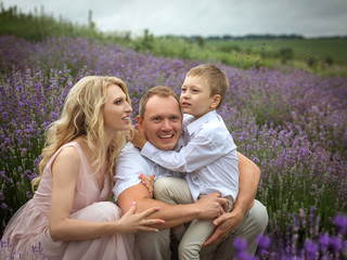 Fototapeta premium happy family with boy relax in lavender field in summer