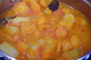 cooking pumpkin soup puree in a saucepan