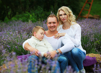 Fototapeta premium happy family with boy relax in lavender field in summer
