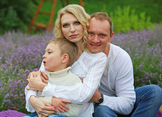 Naklejka na ściany i meble happy family with boy relax in lavender field in summer