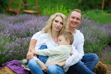 Fototapeta premium happy family with boy relax in lavender field in summer