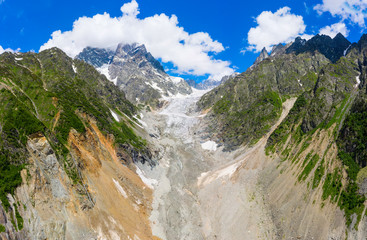 Fototapeta na wymiar Caucasus Mountains on the border of Russia and Georgia. Chalaat Pass and Very beautiful view of the Chalaadi Glacier, Mount Ushba and Mestiachala river with background of clear blue sky.