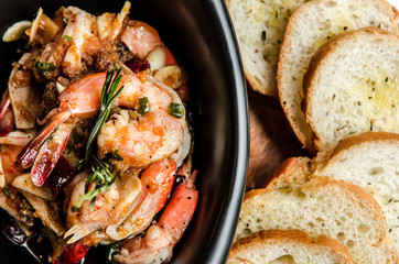 spicy shrimp scampi sauteed in butter and garlic and rosemary with baguette.