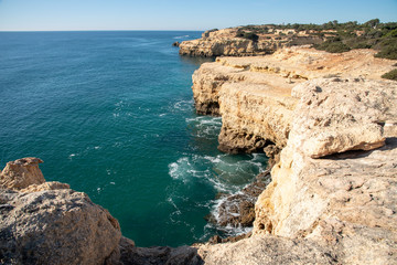 high cliffs on the shore of the Atlantic Ocean. Portugal. Algarve.
