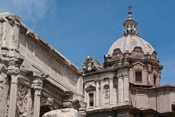 Obraz premium The ruins of a Roman forum. The domes of Roman churches on a sunny day. Rome, Italy