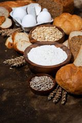 assortment of baked goods and fresh bread, vertical