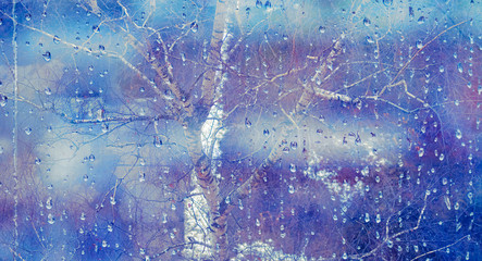 Glass wet autumn background, rain in the park glass wet surface, rain drops on the drenched window glass. Autumnal rainy landscape blurred.