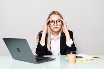 Young businesswoman depressed looking at laptop at office desk