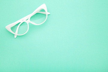White glasses on the mint background, top view