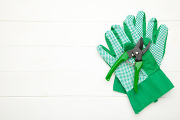 Gardening tools on grey concrete background, top view