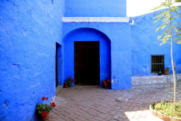 Doorway of the vivid blue old stone building inside Santa Catalina Monastery Complex, Arequipa, Peru