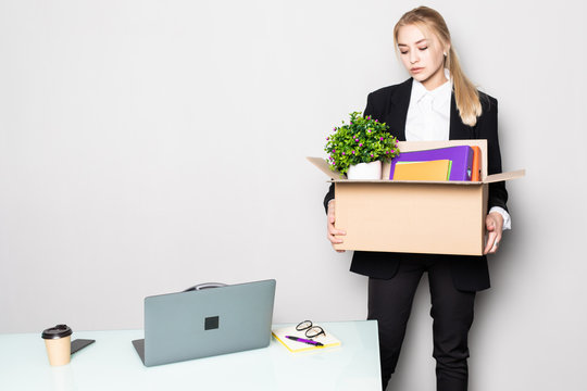 Waist Up Portrait Of Happy Young Businesswoman Holding Box Of Personal Belongings Leaving Office After Quitting Job