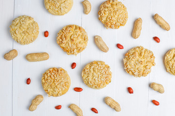 Homemade crunchy cookies with peanuts on white wooden background,top view