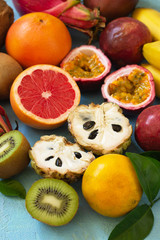 Fruit background. Assorted ripe juicy Exotic asia summer seasonal fruits on a blue stone background.