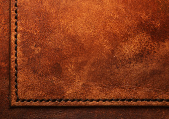 Hand stitched leather showing dark brown waxed thread closeup full frame macro on vegetable tanned...