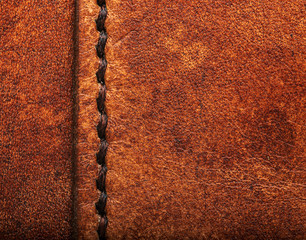 Hand stitched leather showing dark brown waxed thread closeup full frame macro on vegetable tanned...
