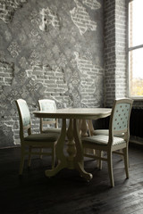 A set of furniture for the kitchen in the loft interior. A collection of chairs and tables for dinner in the family circle.