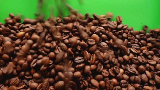 Coffee background on green screen.HQ coffee transition video. Falling coffee concept. Top view of freshly roasted coffee beans