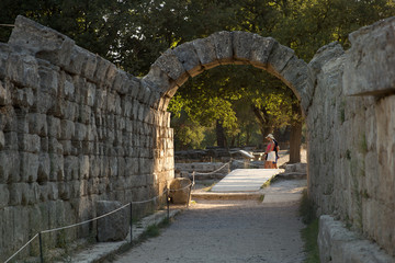 Ancient Olympia, Greece - August, 29, 2019. Ruins of Greek Crypt (arched way to the stadium) at the Ancient Olympia archaeological site, Peloponnese, Greece