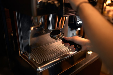 young guy using coffeemachine , close up cropped photo, first helper for housewife