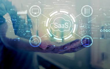 SaaS - software as a service concept with young man holding his hand