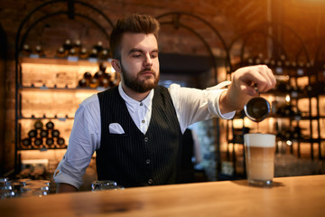 handosme bearded man is keen on making coffee, close up photo