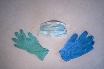 Blue surgical mask and gloves background. Medicine, healthcare and dentistry. Infection and spread protection and prevention. Coronavirus COVID-19 outbreak.