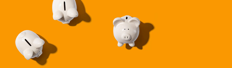 White piggy banks overhead view - flat lay