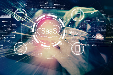 SaaS - software as a service concept with man using his tablet computer