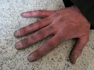 Dirty hand of a chimney sweep. Close-up of a dirty male hand.