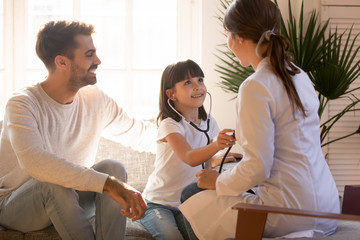 Obraz premium Happy family have fun playing doctor game together