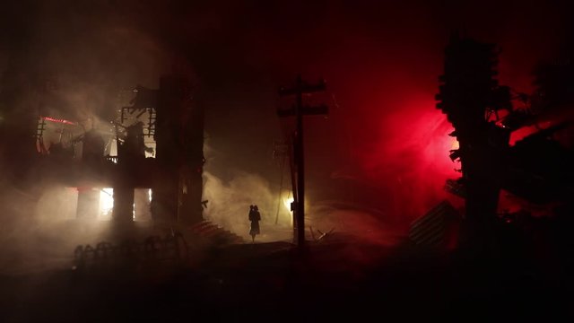 Mother carrying her child in destroyed city. Terrible face of war concept. Creative artwork table decoration with light and fog. Selective focus.