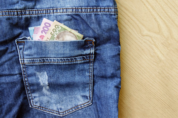 Ukrainian national currency in the back pocket of jeans.