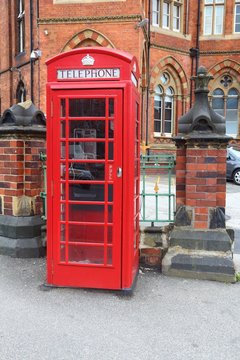Leeds, UK. Red telephone and Leeds General Infirmary in background.