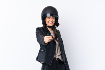 Young brunette woman with a motorcycle helmet and holding a key over isolated white background