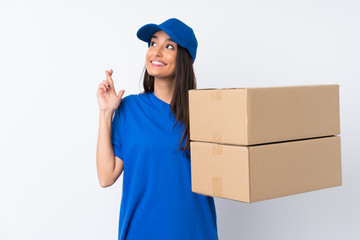 Young delivery woman over isolated white background with fingers crossing