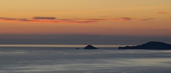 Tino Island with lighthouse at dusk