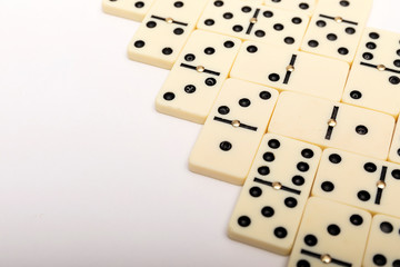 Parts of game of domino on white background with copy space for text.