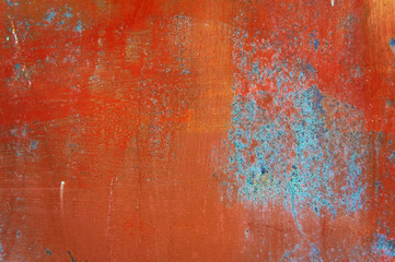 Old iron background painted in brown and blue with rust and chips.