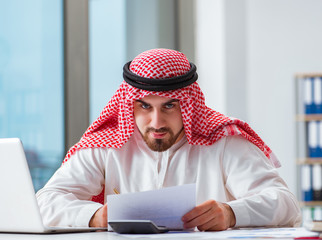 Arab businessman working on laptop computer